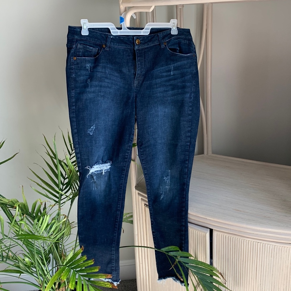 Woman’s jeans with distressed details.